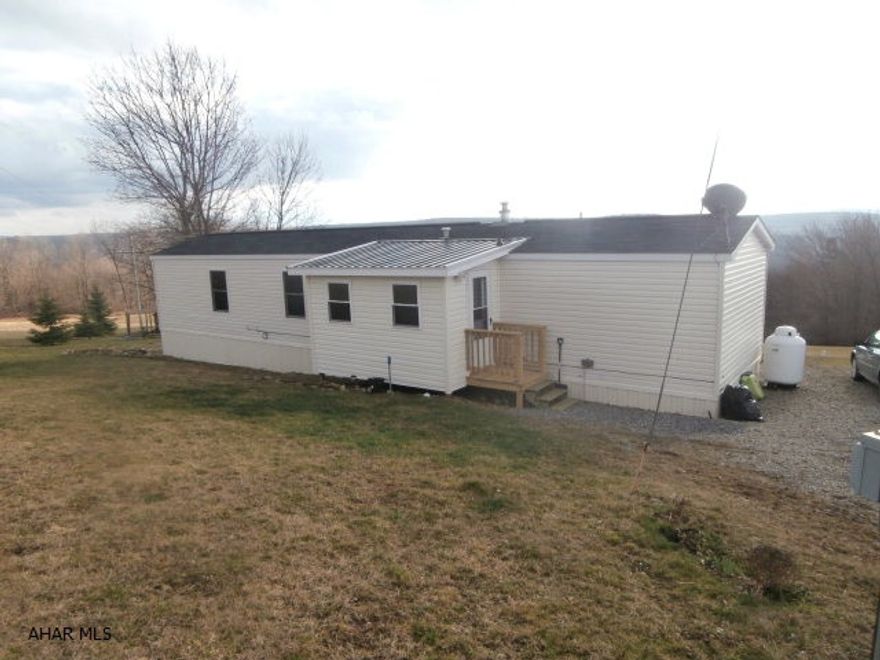 Very nice well maintained single wide on over 4 acres. Great view - minutes from Prince Gallitzin State Park.  Piers installed to code. Enclosed porch and rear deck. Low heating costs.