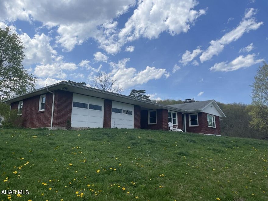 This lovely home was completely remodeled in 2020 with some very nice touches.   Spacious kitchen features stainless steel appliances, large apron sink and granite countertops.  Living space is open concept and both the upstairs and downstairs family rooms have propane fueled fireplaces.  3 garage spaces for plenty of parking and storage and over 3 acres for lots of outdoor living and activities.