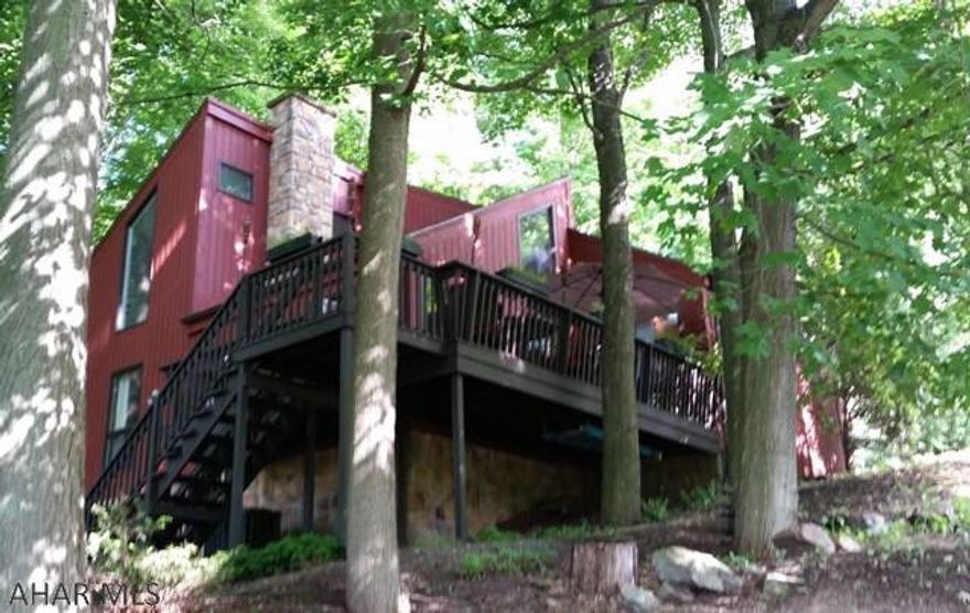 Nestled in the trees & beautifully secluded on 1/2 acre lot allows nature lovers to enjoy country living within minutes of historic downtown Bedford/Omni Bedford Springs. Architect owned & remodeled, quality design & construction is sure to please the most discriminating buyer with its soaring cathedral & vaulted ceilings, granite counter tops, floor to ceiling stone fireplace, hardwood floors, custom bathrooms, walk-in closet, built-in wet bar & so much more. Ever popular open concept floor design is surrounded by walls of windows and skylights adding abundant natural light. Outdoor living space, which includes a secluded terrace, private deck and fenced yard allows for peaceful relaxing and maximum entertainment value. The lower level incorporates a great office, family & exercise room.