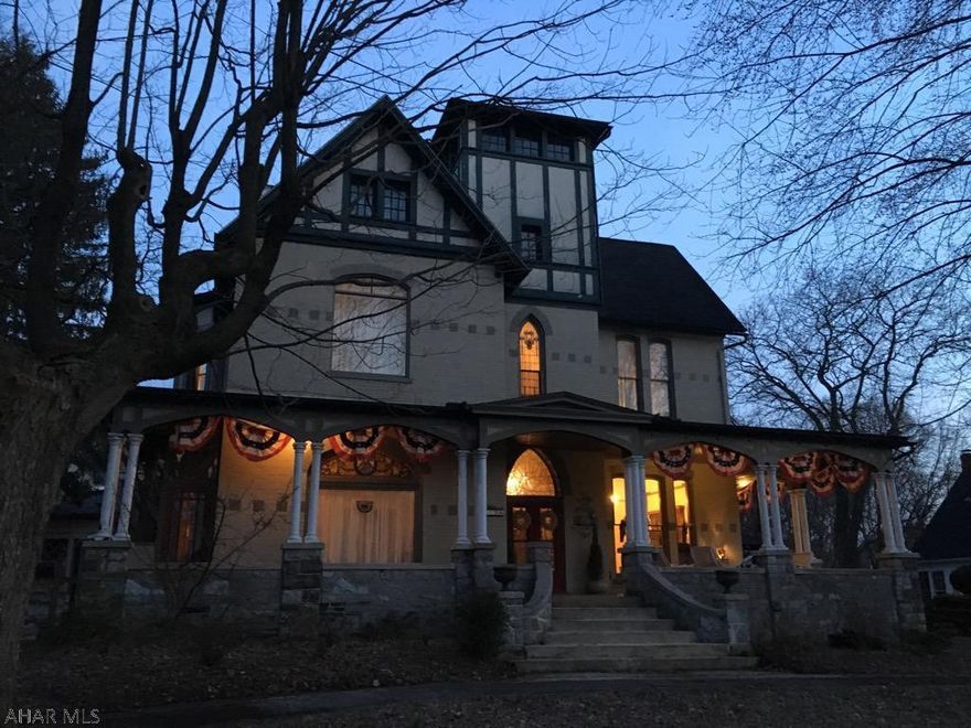 Fall in love with this spacious Victorian Master Piece. Outstanding woodwork, 12ft ceilings, original stunning stain glass windows and beautiful hardwood floors. Kitchen was just freshly renovated to add that Extra" Wow" factor. Huge Master suite with fireplace. You will be surprised to find the operable elevator and walk up attic w/tons of storage. Wraparound front porch with lovely tile floor. Detached 2 car garage w/potential for a art/craft studio or apartment above. Home has an over sized yard. Come take a look and become Enchanted by this Breathtaking Home.