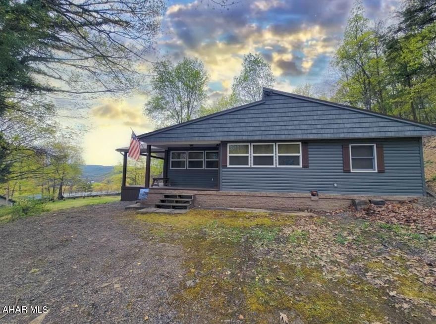 RAYSTOWN LAKE VIEW!!!  3BR 1 3/4bath cozy 1 story home with a covered porch on an approx. 1 acre lot with a rare view of Raystown Lake.  The home entails many personal touches/updates which makes it special.  It's located within close proximity to several boat launches including James Creek, Aitch, Tatman Run and Shy Beaver and is also close to the Raystown Resort.  It also features a detached double garage with a single bay door.  In addition, it's located near 1000's of acres of public hunting.  This home features all amenities and is turn key.  Perfect for full-time residence, vacation home or Air BNB/VRBO.   Call today to schedule a showing. (Pre-approved buyers only.  Taxes, square footage and lot size to be verified by the buyer.