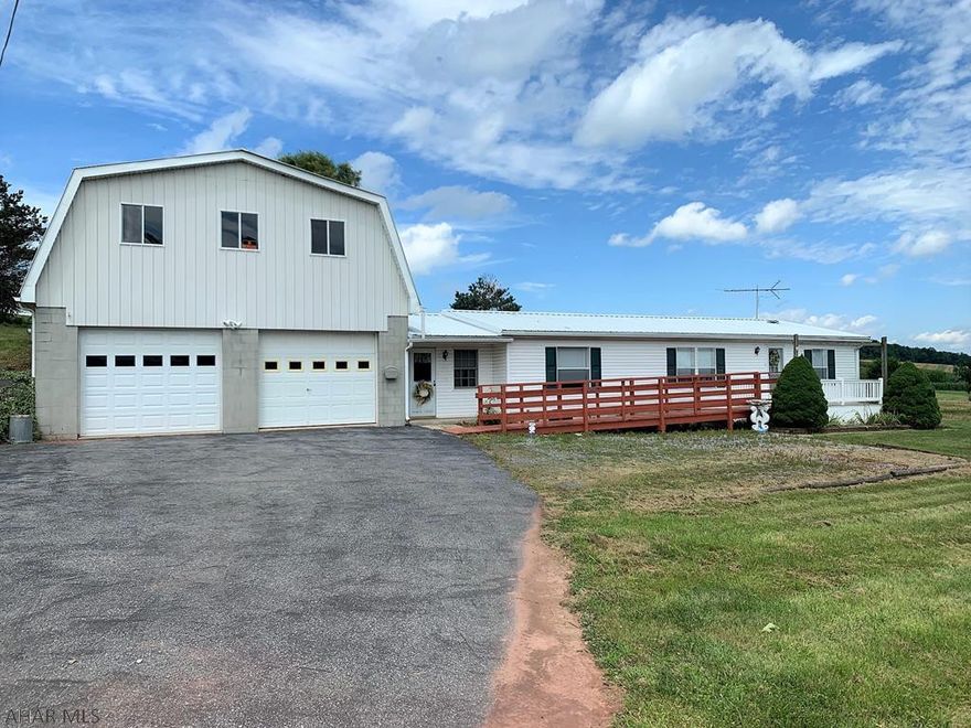 Private country setting and relaxing views!! One-story manufactured home resting on a full foundation. Main level offers a living room, kitchen, dining area, laundry area, owner's bedroom with en suite bath and walk-in closet, two additional bedrooms and another full bath. Fully enclosed breezeway leading to an over-sized, two-story, three-car garage. Full unfinished, walk-out basement, oil forced air heat, central air-conditioning and 100-amp and 200-amp electrical services. Updated metal roof, private well, private septic and a 1.26 acre lot. Kick your feet up on the front deck while watching the wildlife around you.