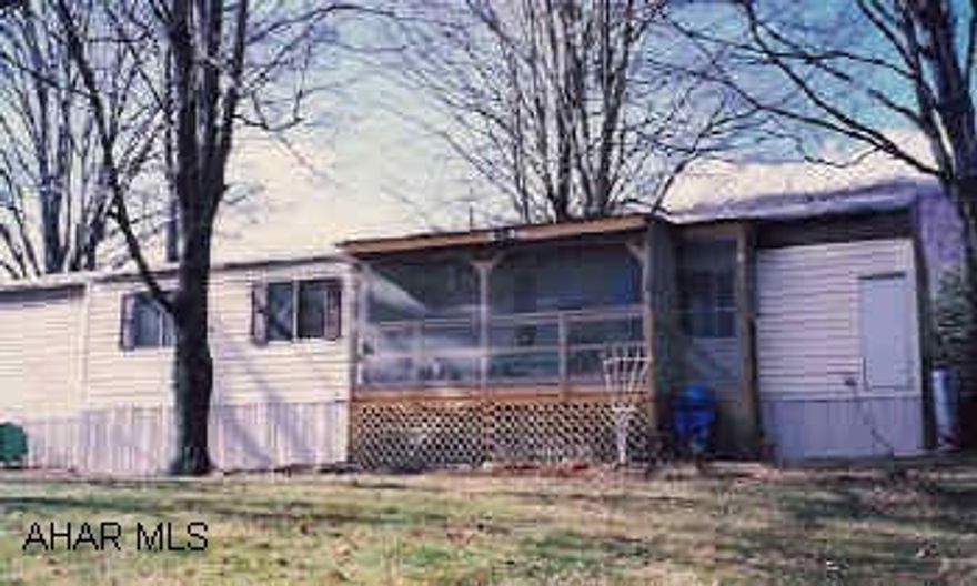 First rate 14' x 70' mobile home with 6' x 28' bump out, screened 8' x 16' rear deck on large wooded lot in country setting.