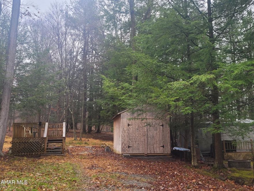 Nice flat campsite that backs up on private land.  This lot is ready for use with all utilities along with a shed and deck.  Just add your camper.