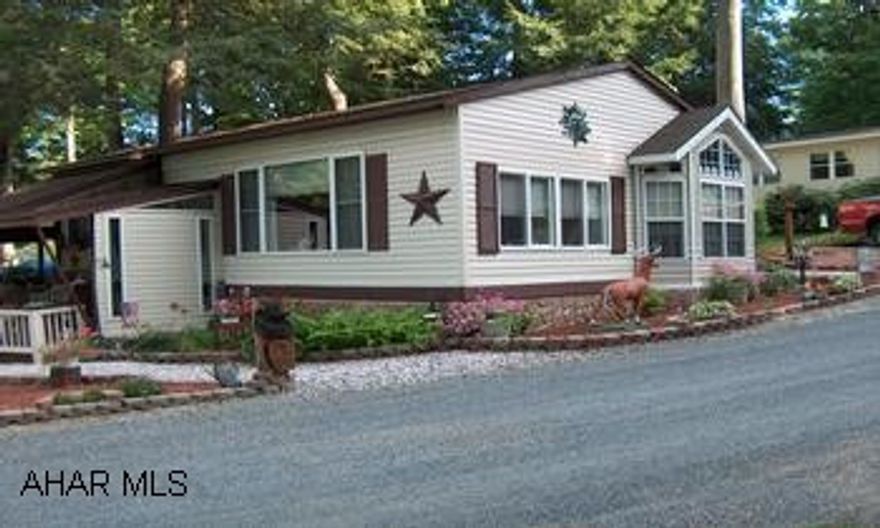 ABSOLUTELY BEAUTIFUL PARK MODEL WITH FULL SIZE ADD ON, MUST BE SEEN LIVING ROOM WITH PROPANE FIRE PLACE, EAT IN KITCHEN, FULL SIZE APPLIANCES, FRONT LOADING WASHER / DRYER, CHERRY WOOD IN LIVING ROOM, VAULTED CEILINGS,  NEXT TO STATE GAME LAND & STATE PARK,  CLOSE TO ROCK RUN.