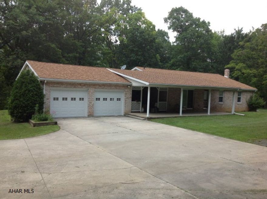 Nice Ranch Brick Home on 4 acres. Private setting and near town. Spacious 3 bedrooms and 1 3/4 baths. New furnace and rec room. Large yard and additional multi car garage or great for horses. Corral behind garage.