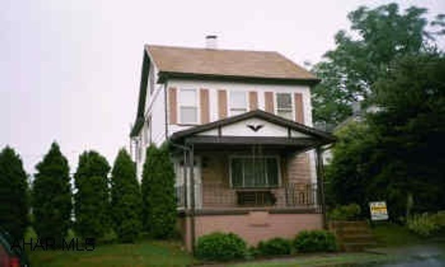 2 story white house with new porch.