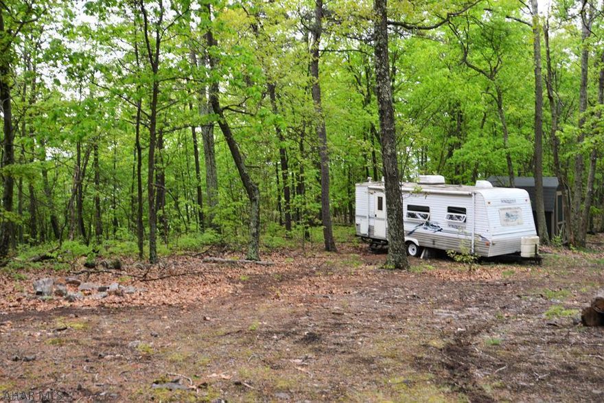 17+ Acre parcel of land located in Southern Bedford County, PA. This property would make an excellent location for a getaway or full time residence. Seller is planning on leaving the camper along with the shed and has an established shooting range setup for someone looking to target practice or shoot in their hunting rifles. Property is located within a mile of State Game Lands.