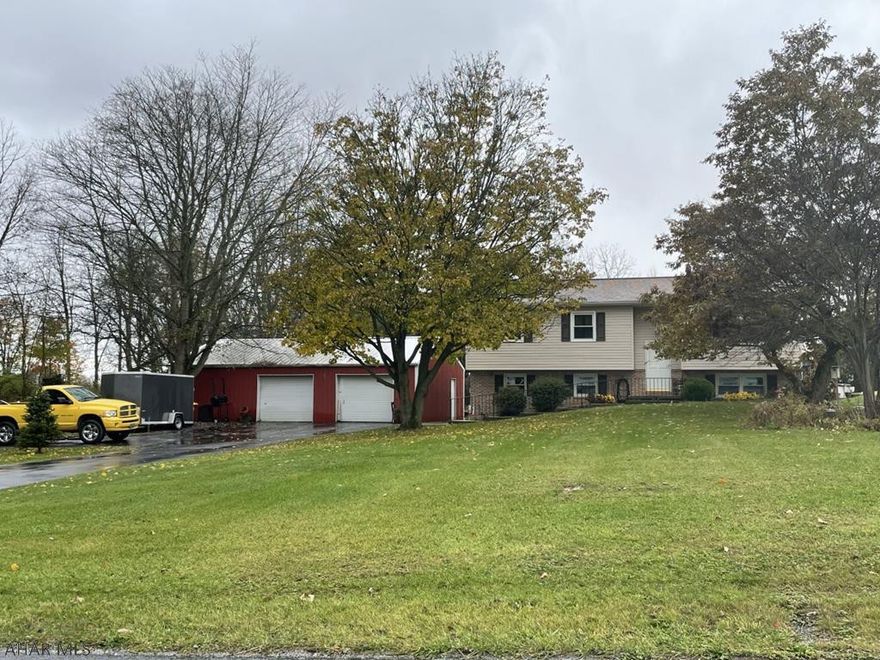 Talk about the best of both worlds!  This lovely home is located outside of town on a quiet country lane yet is just minutes from town.  This home features 4 bedrooms and 2-1/2 baths.  Updates to this home include the addition of central air and finished basement.  The large rear deck overlooks a well-maintained pool making it an excellent entertainment area.  The large detached garage has space for 3 vehicles and has a great workshop area as well as extra storage space.  A great house for the money.