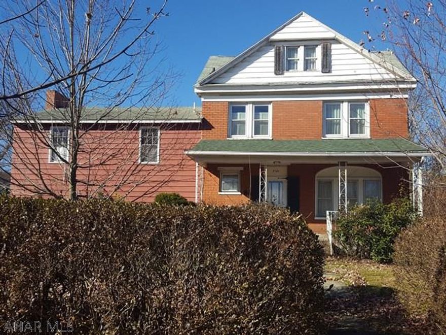 Large, brick home on E. Wopsononock Ave.  Covered front porch, leaded glass windows intact.  Family room with stone fireplace and two car garage with half bath.  This home has tons of potential.  Call listing agent to see this home at your earliest convenience.