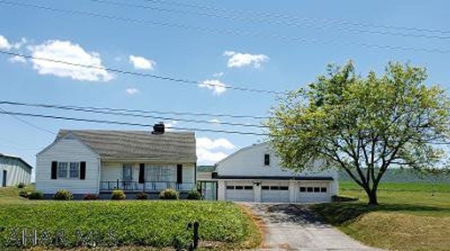 Nice 4-bedroom 1-bath capecod with modern Kitchen, Living Room with fireplace & 2-story concrete block 3-bay garage w/workshop above.  J-512