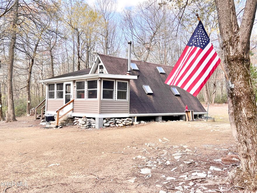 Secluded cabin resting on 10+/- acres located not far from PA State Game Lands.  Property offers a one bedroom cabin with Solar, Propane, and Generator hookups, cistern for water, privy, and multiple outbuildings. Would make a great hunting camp or getaway! No septic system currently on site and no electric is available on the Mountain, Seller uses Solar, generator, and Propane.