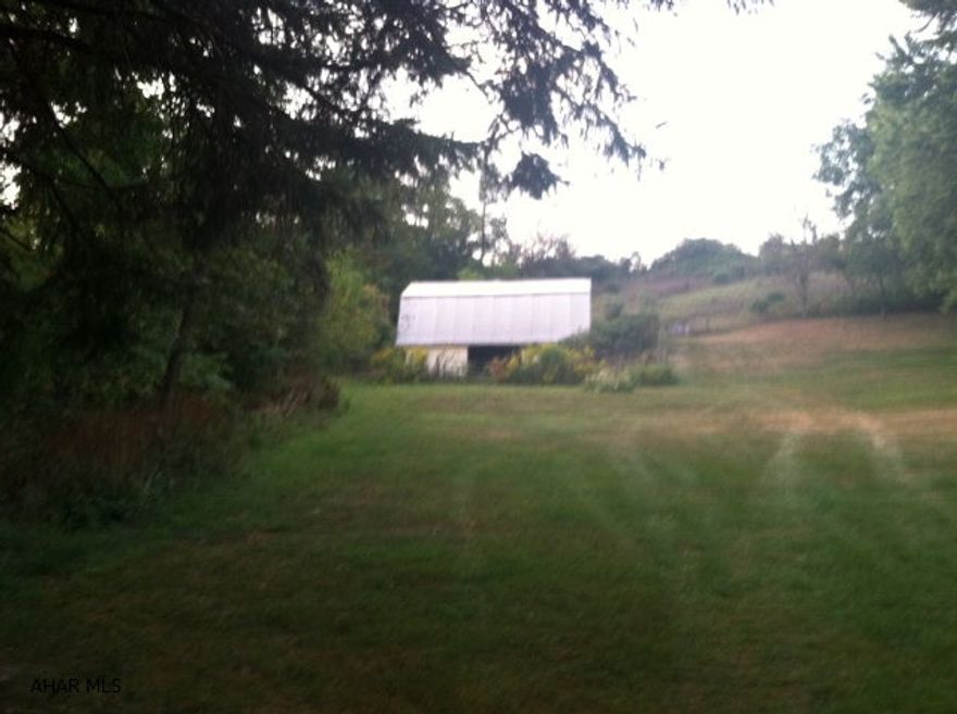 One of the last-- A building lot that is on a secluded Cul De Sac Road above Canoe Creek State Park. Home could be built to have view of Canoe Creek. There is a 2 story 26x32 Concrete Block Horse Barn on property.  Sewage line is at the road, sewer tap is needed. Would need to drill a well.