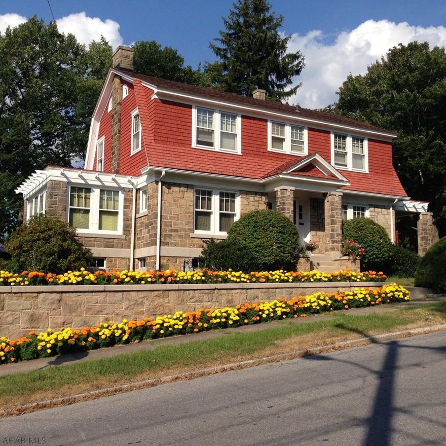 2 story - 4 Bedroom, 1 1/2 Bath sandstone & wood shake exterior on double corner lot.  Large decorative plaster crown molding accents the LR, DR, & Foyer areas.  Formal DR has wood wainscot w/french doors to a quarry tile side porch as well as french doors leading to the foyer, Large LR with gas fireplace w/french doors leading from the foyer.  Hardwood floors & trim throughout.  Eat-in kitchen with appliances included.  Large heated sunroom as well as first floor office/den.  1/2 bath off kitchen.  All four bedrooms are spacious.  Gas hot water radiator heat.  Three quarry tile porches accent the home.  Those that love old homes with character, this is one of kind opportunity.  Move-in condition.  Owner installed new 200 amp electrical service and sewer certification has been completed.