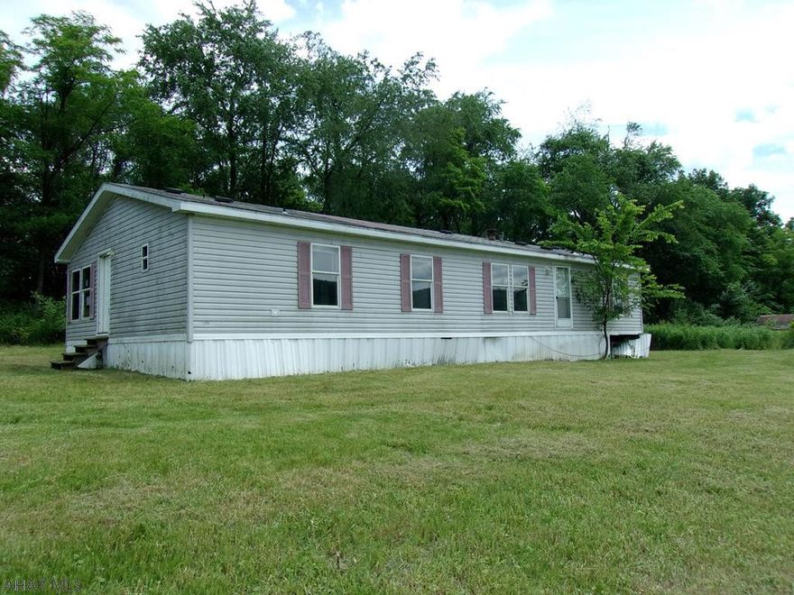 It's all about the view! Each season will be a delight. Doublewide could be a rehab project or make this the building site for your new home. 3 acres w/workshop/ barn.