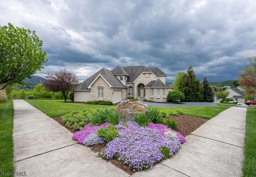 Very well maintained brick and vinyl home...views of Chimney Rocks and Allegheny Mountains. 4 BR's, 3.5 baths.  1st Floor owner's suite with tray ceiling, private deck, walk-in closet and spacious bath, complete with jetted tub and double sinks.  Additional 1st floor amenities include a kitchen (appliances stay), b-fast rm, DR or Office area, half bath, laundry/pantry and a Great Room with vented gas FP, doors to deck and Cathedral Ceiling. Upstairs you'll find 3 additional bedrooms, a full bath and access to a storage area above garage. Downstairs is a FR, Hobby area (plumbed for a wet bar), 3/4 bath and lots of storage...walk out to a patio with pergola. Zoned heating, corner lot, professionally landscaped and a park and Penn-Mont close by.  Easy access to Rt 22, downtown Hburg and 99.