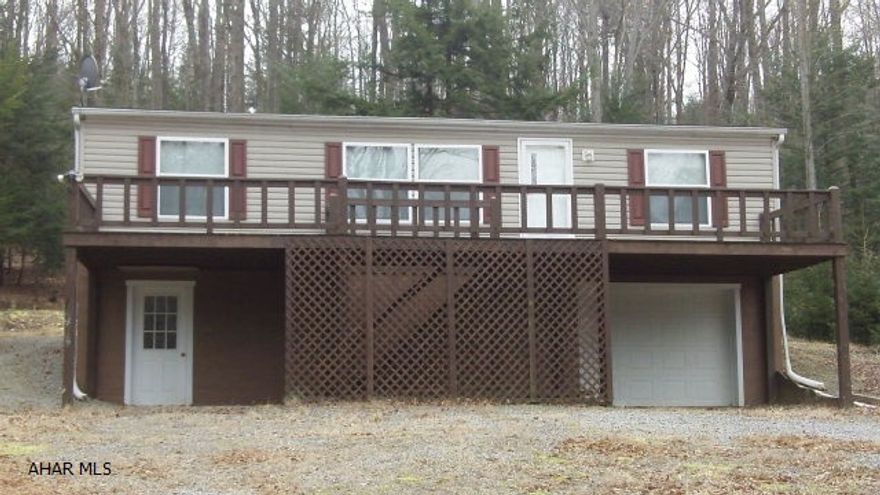 Looking for a semi-private wooded setting, lots of room and not empty your wallet?  Here is the place for you.  Half acre backed up against and extending into the woods.  This double wide offers 3 bedrooms, including the master suite that has a large bathroom and walk-in closet.  All of your living space is on one floor while below you have a one car garage and plenty of open space for your family room, man-cave or storage.  Two oil tanks are in the basement for your forced air heat.  There is a full deck out front and the partial deck in the back overlooks the woods, your horse-shoe and fire pits.When you are ready for activity, visit the community swimming pool or play basketball, volleyball or tennis.  Glendale Lake, State Game Lands 108 and Rock Run are nearby.  Home warranty! New roof