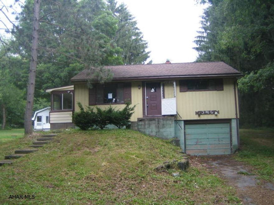 Sinking Valley home on nice .82 acre lot in need of TLC. 2 bedrooms, living room, eat-in kitchen, sunroom, 1 car integral garage. AS-IS sale.