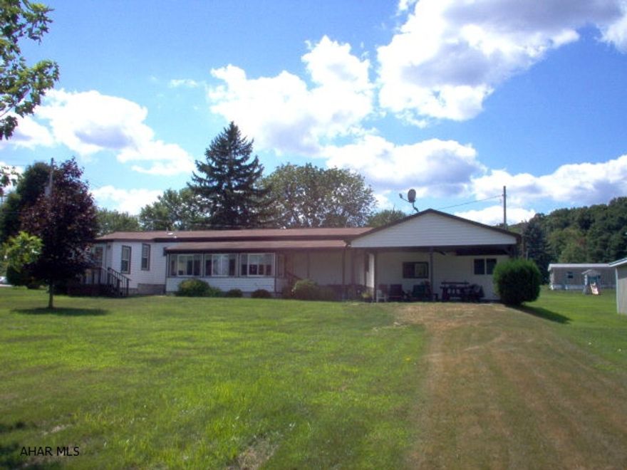 Retirement home or second home, take life easy in the well maintain property.  Level half acre lot, great sun room, 24'X24' covered patio, one car garage and work shop.  Convenient location to highways, shopping, medical; yet with rural atmosphere.  Single wide manufactured home with additions, quality work.