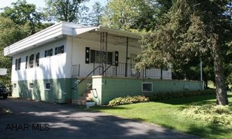 Loads of potential in this quaint 3 BR, 2 bath raised ranch home on 1.65 acres with beautiful stream and woods.  Hardwood (under carpeting), modern kitchen, covered front and back porches, large 3 car garage w/ greenhouse.  Basement w/ walkout. Loads of potential in this quaint 3 BR, 2 bath raised ranch home on 1.65 acres with beautiful stream and woods.  Hardwood (under carpeting), modern kitchen, covered front and back porches, large 3 car garage w/ greenhouse.  Basement w/ walkout, painted and floored with kitchen & fruit cellar.  Very good condition!  More details at www.CAROLGARDINER.com