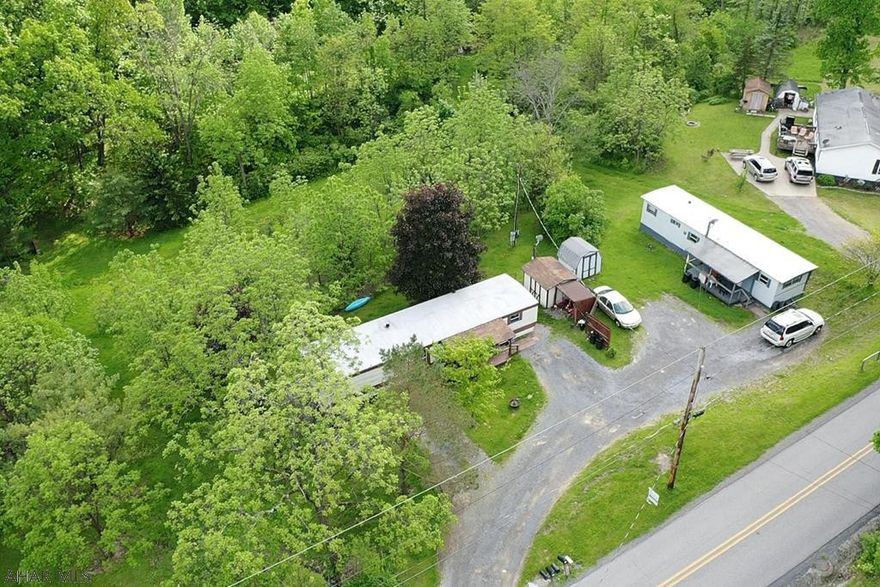 2 single wide mobile homes on approx 2.59 acres.  Great investment opportunity or live and one and rent the other out.  Rent is $585 per month for 250 and $545 per month for 242!  Both homes are currently occupied. 242 is a 2 bed 1 bath 1970 Brookwood and 250 is a 2 bedroom 1 bath 1985 Champion.