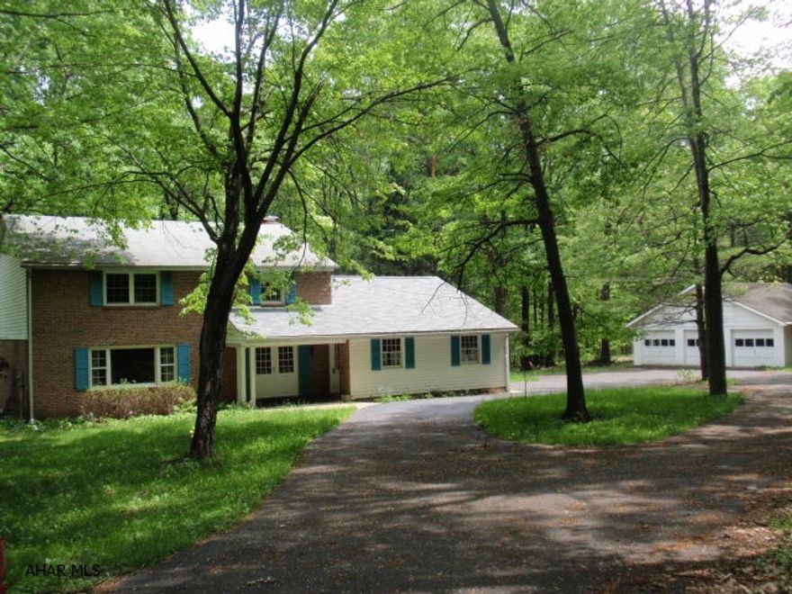 5.9 miles from Kettle Street and Pleasant Valley Boulevard, house is on the left.  Absolutely beautiful setting.  Good quality large home with hardwood floors.  Kitchen updated in 2004 with oak cabinet refacing.  Original baths dated to late 60's.  2 car attached garage, 3 car detached garage.  Recent survey indicates property adjoins State Game Lands.  Owner is looking for offers!