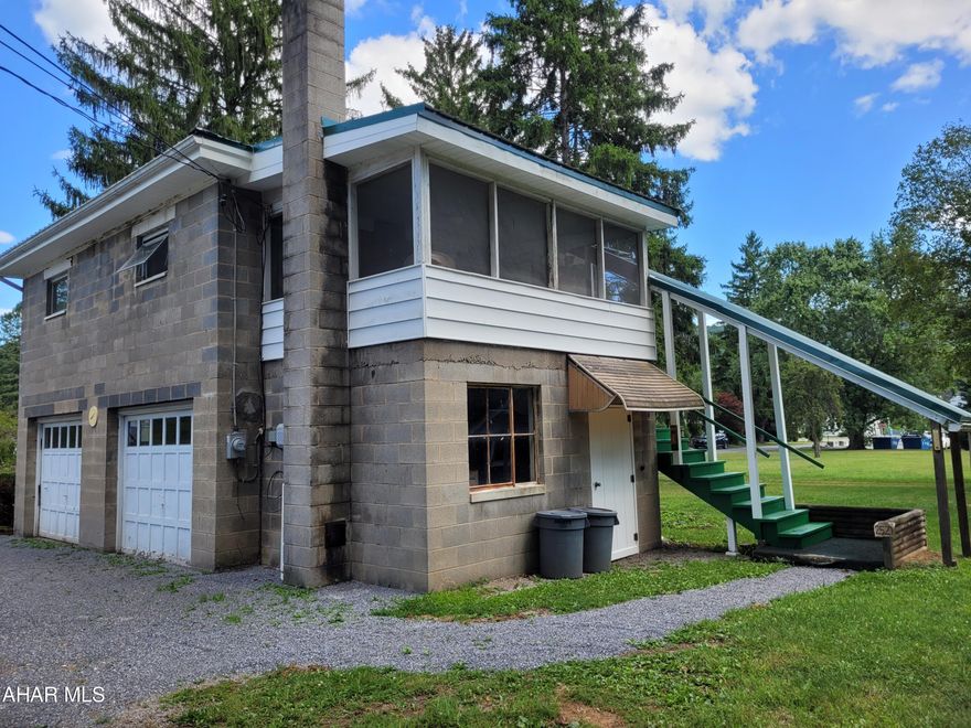 Lots of options !!!   One bedroom raised rancher over nice 2 car block garage. New metal roof. Screened rear porch. Perfect to live in or use the garage and let the upstairs unit help pay for it. There is no zoning so you could potentially use it to run your small business. Call for details.