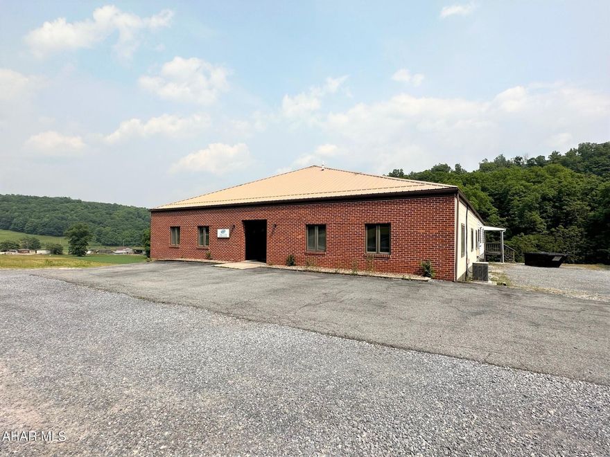 This property consists of a one story building containing 5,500 SF.  Approximately 3,850 square feet of light manufacturing area, 650 SF of office space and 1,000 SF of material storage area.  Loading dock, concrete floor and several entry and exits.  So many potential uses with the building including its current use of light manufacturing or professional office space, distribution, warehousing, or retail.  Building currently has a heat pump with central air for the office space and propane radiant heat and wall a/c units for the other areas.  Three 200-ampere electrical service, a private well and private septic system.  3.736 acre lot with a large macadam and gravel parking area. Three large sheds on site that transfer with property.  Terrific location for easy access in Bedford Township with no zoning and just minutes to Bedford and convenient to the PA/MD border.