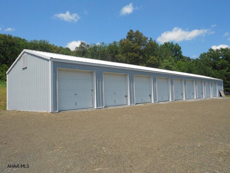 Don't miss out on this great investment. Twelve storage units, 9 w/ overhead doors and 3 w/ regular doors. Fully rented sitting on 1.82 acres. Could have a beautiful building site behind them w/ a lovely view.