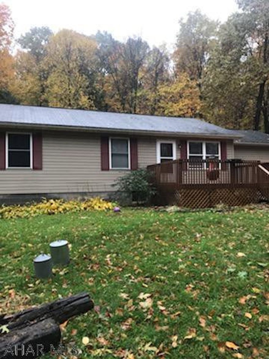 Spacious and Private 3 bed 2 bath ranch nestled in the woods.  Enjoy hunting and outdoors on this 1 acre lot nestled in the woods.  Newly painted and flooring throughout.  Attached garage converted to office, workshop and storage.