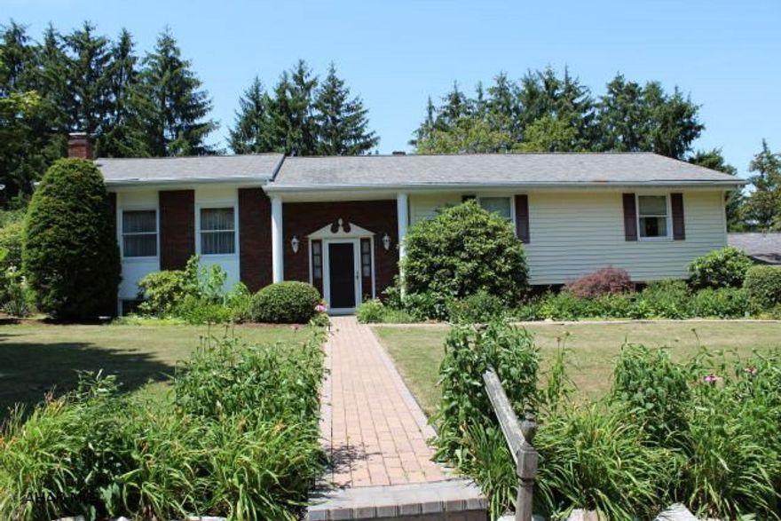 So much to offer!! Country living close to town, spacious rooms with hardwood floors, main level, handicapped accessible complete with elevator, Gorgeous cherry kitchen with corian counter tops, stackable washer and dryer. Lower level offers a mother-in-law option with fully equipped kitchen, 2 baths, family room with fireplace, tons of storage and a possible 4th bedroom. Not GPS accessible - Rt 36 South, first exit past Hollidaysburg to Loop Road, bear right and go 1 mile past exit, turn right on Manor park Drive, right onto Maple Drive, 1 block to Charcoal, first house, red brick, yellow siding.