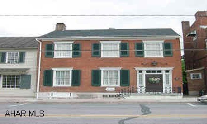 Historic brick colonial featuring numerous fireplaces, large private porches, and built in cabinetry that can't be reproduced in a new home!  Large, level lot with a carriage house and rear alley access. Close to town.