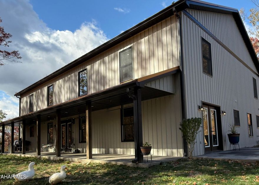 This stunning barndominium combines stunning character with thoughtful modern design and a commitment to energy efficiency. Constructed with exceptional attention to detail, it features radiant two-zone floor heating throughout the main living areas providing year-round comfort and warmth underfoot.

The open layout showcases soaring ceilings and an inviting neutral palette that offers endless versatility and is ready for any style, whether contemporary, farmhouse, or classic Joanna Gaines-inspired charm. Along the entire side of the home, a covered, expansive seating area provides the perfect place to relax and take in both sunrises and sunsets, with panoramic views of the surrounding mountains.

Nestled on 10 very private wooded acres, the property attracts abundant wildlife, including deer, wild turkey, and the occasional black bear. The peaceful sound of a nearby stream adds to the tranquil setting, creating a soothing natural backdrop for outdoor living. A former pond site also offers an opportunity for future restoration if desired.

Inside, the main floor includes three bedrooms, one currently used as an exercise room along with a convenient laundry room with exterior access. Upstairs, two additional bedrooms and two loft areas provide flexible living space, while the home features two full baths and a powder room on the first floor.

The master suite is a true retreat, featuring private French doors that open onto a secluded patio overlooking the natural surroundings. It offers a spacious walk-in closet and a thoughtfully designed bath with a soaking tub, an expansive tiled walk-in shower, and dual sinks for added convenience.

The garage, located just steps from the home, was thoughtfully designed to accommodate an apartment, workshop, or home office. Once completed, it could serve as an exceptional extension of the living space. Its proximity to the main home also allows for the future addition of a covered walkway between the two structures.

Located just minutes from I-99 and Route 30, this peaceful retreat offers easy access to major destinations including Washington D.C., Baltimore, Pittsburgh, and Philadelphia via the Pennsylvania Turnpike.

This exceptional property blends thoughtful craftsmanship, comfort, and connection to nature creating a serene and timeless place to call home.