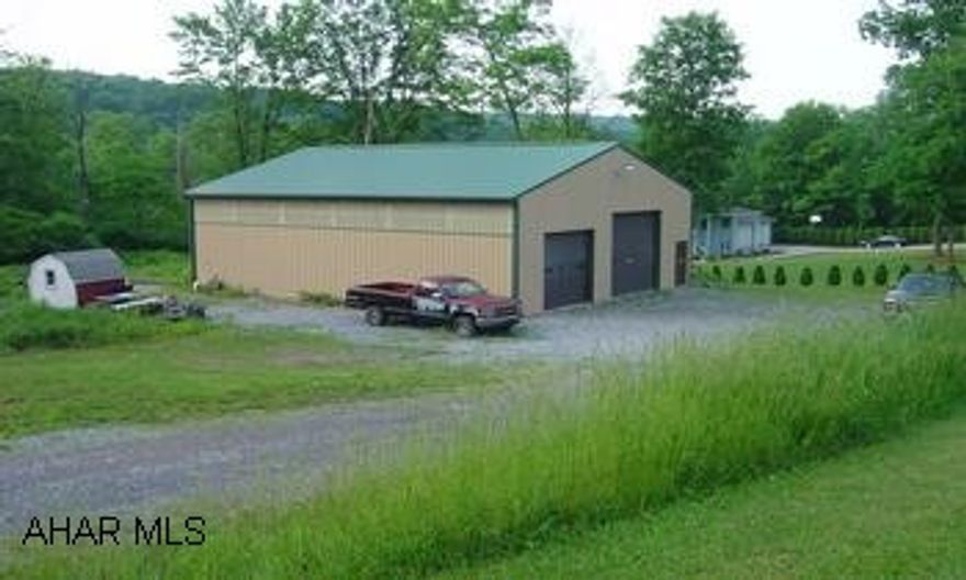 48x40 aluminum garage with car hoist. No well or sewage system. Call office for code.