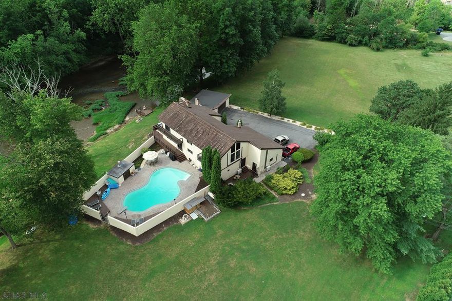 Extraordinary custom built contemporary 4 bedroom, 5 bath home on 1.7 acres w/gorgeous views of the Juniata River.  An impressive newly renovated two story foyer sets the stage to the home's stunning design.  Delight in the waterfront sunroom or impress guest in this newly renovated kitchen while enjoying views of the kidney shaped pool and terrace.  Two master suites, (one with a floor to ceiling brick fireplace and loft overlooking living room) a private guest wing (Top rated Bedford Air B&B) with private terrace and entrance.  Office with floor to ceiling windows and cathedral ceilings make working from home a joy.  The home's newly installed separate zoned air conditioning and heating system add unbelievable energy efficiency.  This is a spectacular home!