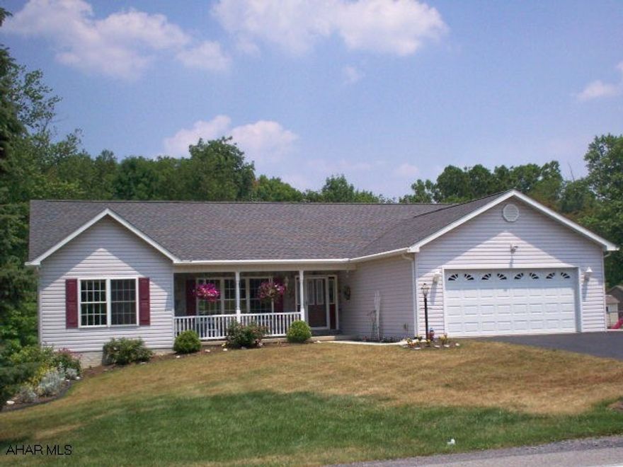 Priced to sell,this beautiful Trademark home built in 2004 has been pristinely maintained and is located just a few minutes from Route 99 and the PA Turnpike.  Vinyl/stone exterior and lovely landscaped yard on over half acre lot. Bright and airy open floor plan, cathedral ceilings in main living area.  Large kitchen has skylights, island, desk area and bar area suitable for 4 stools, appliances are included.  Dining room opens to deck. Master suite includes his and her walk-in closets and master bath has large vanity w/double sink and extra large shower.  Main level laundry room, full basement is spotless.  Also includes outbuilding that matches exterior of house.  Two car garage w/opener, black top driveway. CALL NOW, THIS IS A GREAT BUY!!!!