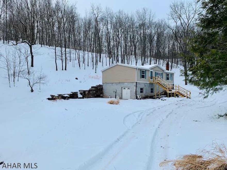 Private and Peaceful 1.95 acres tucked away in mountains for a great get-away or residence! A Ritz Craft home constructed of 2x6 exterior walls, full basement ready to be finished with radiant floors that need hooked up. Basement is plumb for a 3rd bathroom and a 2nd kitchen. New 2020 propane furnace installed, Upstairs 100 amp electric service and basement is 200 amp service. The spring house holds a 1500 gal reserve for your water source. The home is very well maintained, accented with a cathedral ceiling, and skylight in the kitchen. Outdoor living at its best for enjoying those beautiful evenings on the lg. concrete patio relaxing around the firepit and listening to water running in the stream. Fishing near by at Will's Creek and hunting in the State Game Lands just down the road.