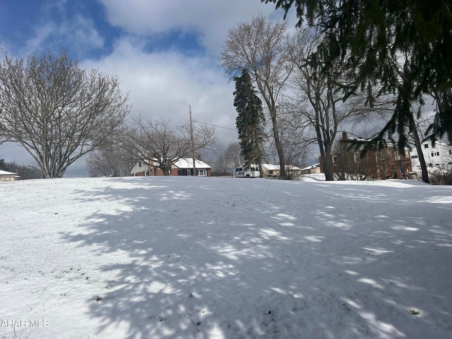 Nice building lot in Hoppel Heights development, Patton. Corner site in lawn with a few trees.