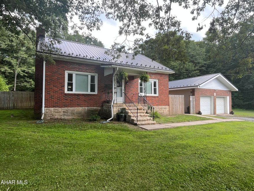 Charming and well-maintained, this classic brick home offers a spacious two-car garage and timeless character throughout. The main level features a comfortable bedroom with two walk-in closets and a full bath, while two generously sized bedrooms await upstairs. You'll love the rich hardwood floors and detailed trim that add warmth and elegance to every room. Downstairs, the clean and expansive basement includes a dedicated workshop, a bonus room with a fireplace—that is waiting for your finishing touches. Step outside to a fenced yard with a pavilion, ideal for gatherings and outdoor fun. Conveniently located just close enough to everything yet tucked away from the hustle and bustle.
20 Min to Altoona 
14 min to Prince Gallitzin State Park
30 min to DelGrosso's Amusement Park
Motivated Seller