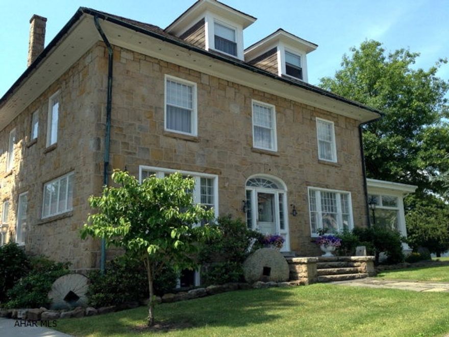 Schellsburg landmark, Millstone Inn. Present owner has professionally improved & maintained this 6000 sqft, 1922 stone colonial. 5 BR, 6.5 BA w/ 4 floors of living. Two stairways, stunning detail, 10' ceilings. A parlor fireplace mantel is an original & signed by Wexford. Beautiful flooring throughout, chestnut beams & woodwork in original part. Ample parking, 6 car detached garage, perennial gardens w/ fountains. All this adjacent to Shawnee State Park.