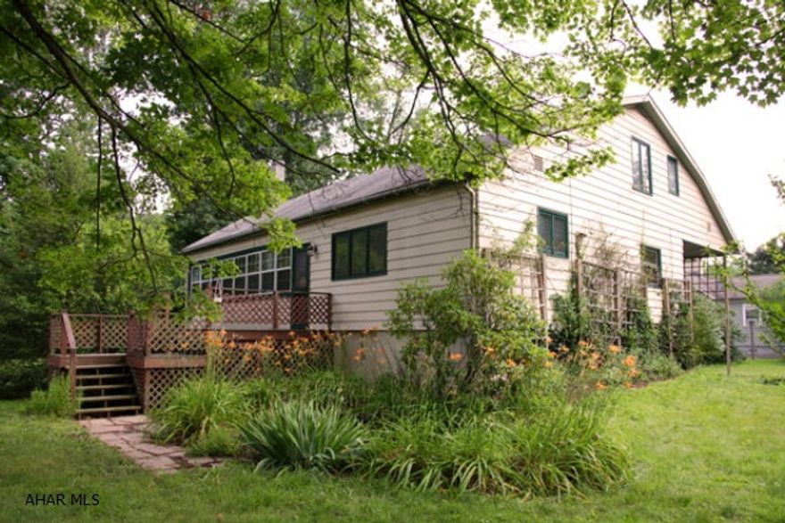 A nice cottage retreat or starter home. Includes 3 bedrooms and 1 1/2 baths on .69 acres of creekside property. Includes a wrap-around deck and single bay garage integral to the basement. There's a spacious closed in porch area, large living room area and large loft master bedroom. First floor also has a large laundry room and one bedroom that can be used as a library or office space. Oil forced-air heating system. Artesian well water supply and city sewage system. A flood elevation certificate has been completed for this property as of 10/01/2012 and a copy is on file at the real estate office.