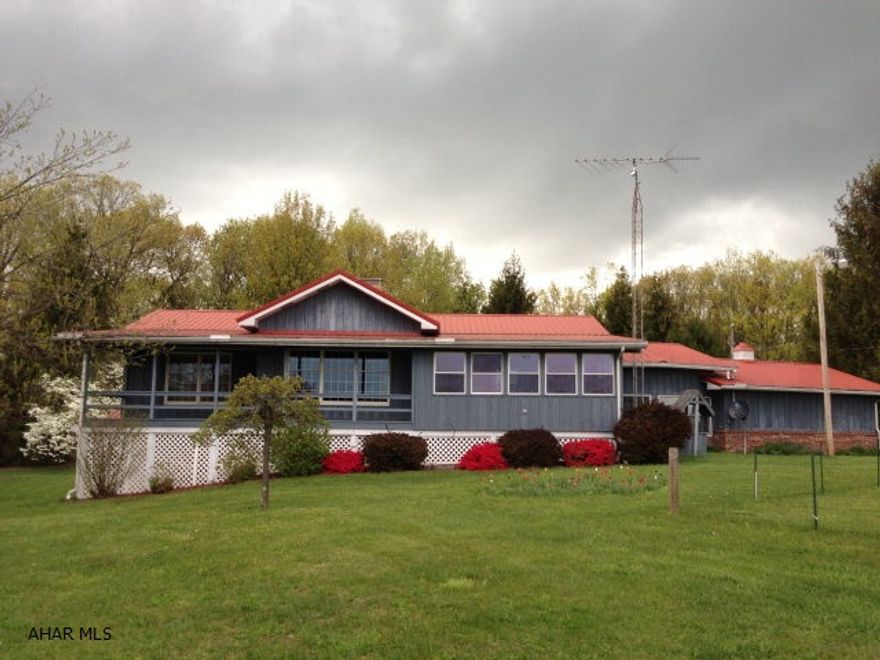 Very nice custom built ranch home on 2.35 acres!! Open dining and living area with bay window and a gas burner. Galley kitchen with pine woodmode cabinets and pantry. Master bedroom/bath has 2 walk-in closets and a private sunroom. Spacious breezeway attaches to the 2 car garage. The basement has a fuctional canning kitchen, shower stall, nice family sauna, woodburner and a walkout to the backyard. Large 228 sq.ft. shed and a 32x26 2 story vinyl sided workshop/garage with 200 amp electric, oil furnace and AC. RV parking space.