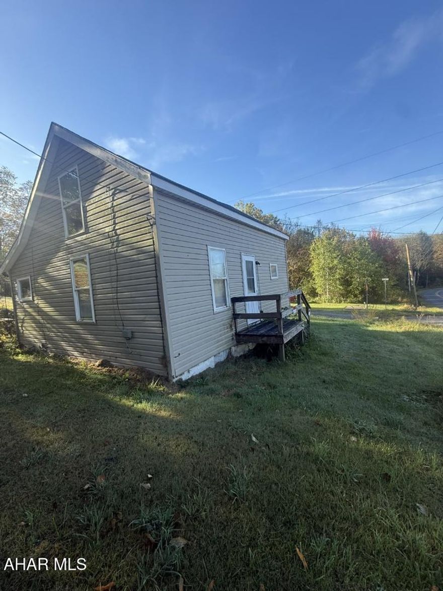 Two bedroom home nestled in on approximately 2.466 acres between 3 separate parcels.  The home is connected to public sewer and has a well.  Public water is available at the curb and would need connected by the buyer according to the seller.  The home had an oil furnace at one time.  Oil tank still present as well as a wood burner in the basement for heat.  Rehab this home to your liking or build your dream home on the lot.  Home being sold as is. No repairs to be made by sellers.

Buyers to confirm taxes, square footage and lot size.  Buyers/agents to sign a hold harmless prior to showing.