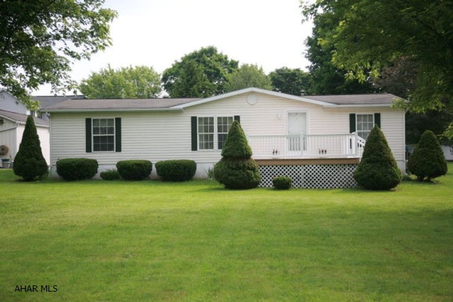 This is a beautiful, well maintained Doublewide in a quiet side street setting with over a half acre of property. It has a large, spacious kitchen and dining area with a food preparation island; a large living room and a well designed master bathroom suite. With three bedrooms, two full bathrooms and a laundry area this ready to 'move in' property would be perfect for a family or someone wanting to downsize. There is a one car detached garage and garden shed on the property. It includes a blacktop driveway and parking area and a large rear-facing deck. The home is situated on a concrete foundation that was built with a concrete slab making maintenance access very convenient.