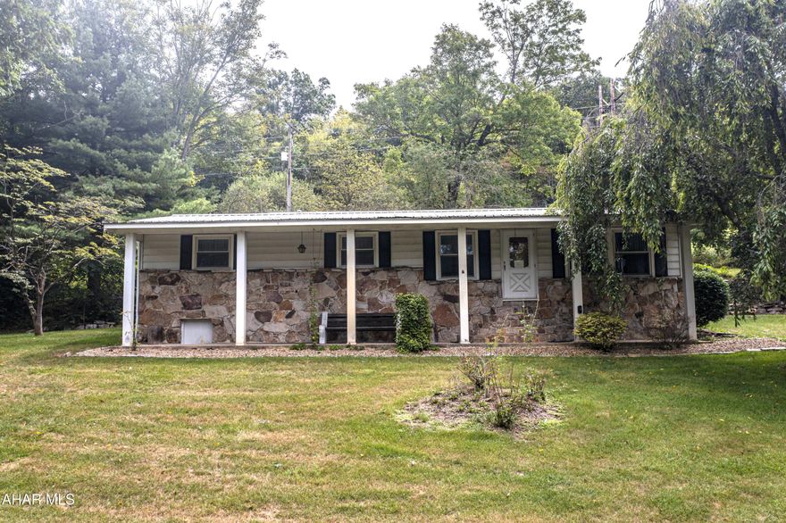 Welcome to this charming property in Freedom Township! This single-story home offers 3 generously sized bedrooms, 2 bathrooms, a spacious kitchen, and a cozy stone fireplace full of charm and character. The unfinished basement provides excellent space for storage or a workshop. Set on 1.33 acres with beautiful views, the property features attractive stonework on the front of the home and plenty of outdoor space to relax and enjoy the peaceful surroundings. A detached 2-car garage includes a 2-bedroom, 1-bath apartment above- ideal for extended family, guests, or potential rental income. Well cared for over the years, this home offers incredible potential for modern updates and personalization, making it a wonderful opportunity to create your dream home in a private yet convenient location!