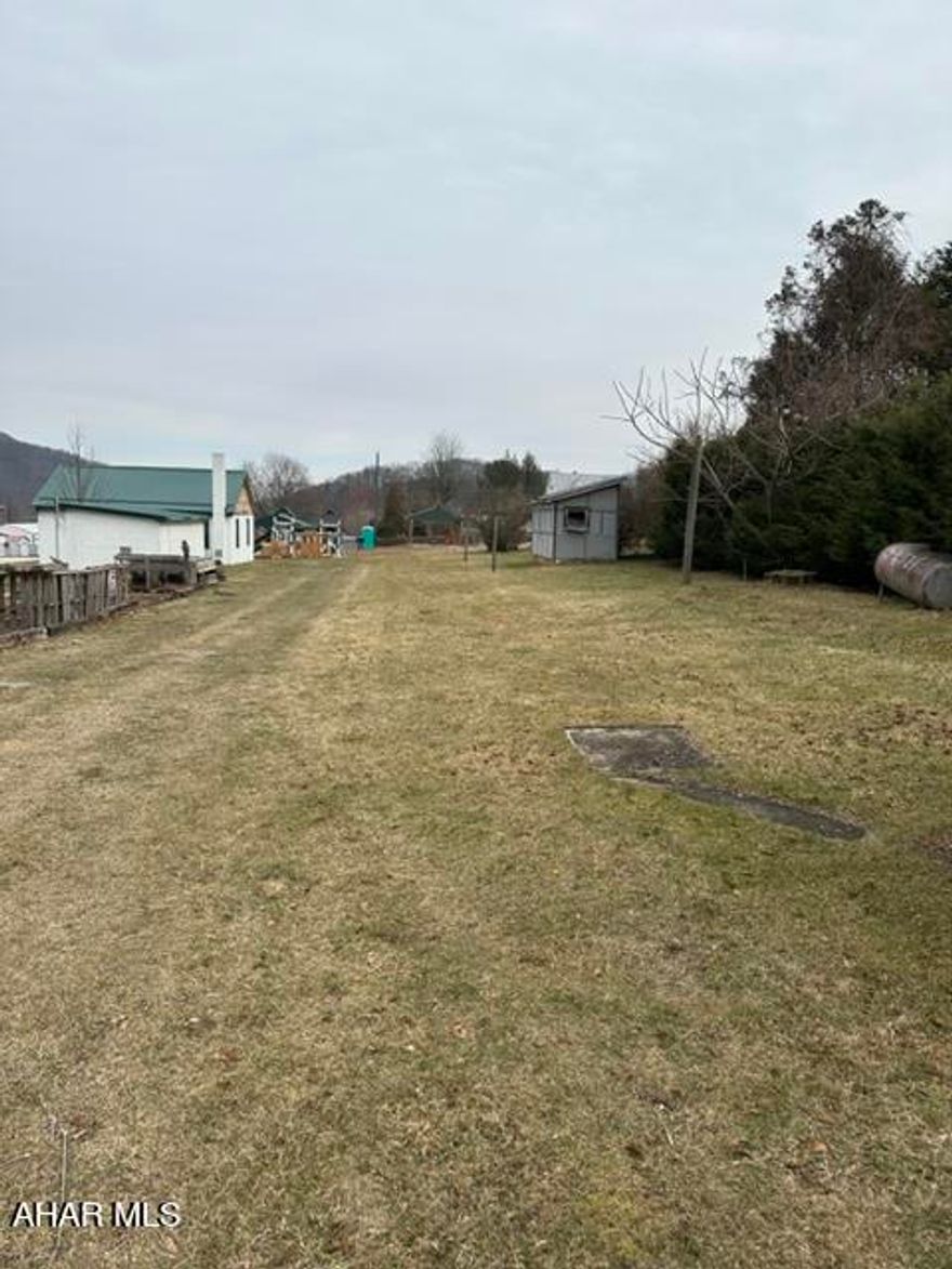 Improved building lots with available public water and sewer. Water and sewer have been capped off.  Shed is on the back of the second adjoining lot. To build home or install trailer please check with Liberty Twp. on variances.  Previously there was a trailer and has been removed all but the 250 gal. oil tank. The lot was leased to the owner of the trailer.
Electric pole is still in place.  The one lot contains .138 acre and adjoining .051. Adjoins unimproved alley.