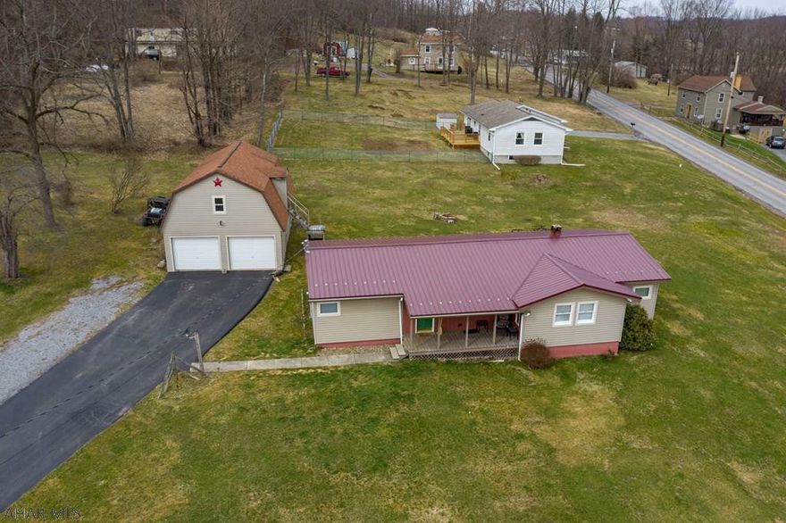 BACK ON MARKET! Check out the virtual walk though tour of this fantastic 4 bedroom, 1 bath home in Houtzdale. This property is situated on 3 corner lots and features a freshwater spring and a large two car, heated garage with a spacious loft area that can be converted into an apartment or even a rec room! Inside the main house, you'll find an open floor plan in the kitchen and living area which features a vaulted ceiling addition. There is one bedroom off the kitchen and another off the large laundry area and mudroom that has access to the back yard and stone patio area. Two more bedrooms are located off the living room. There is also an updated bathroom with a walk-in bath shower. See it virtually on broker website or in listing tour link and make an offer!