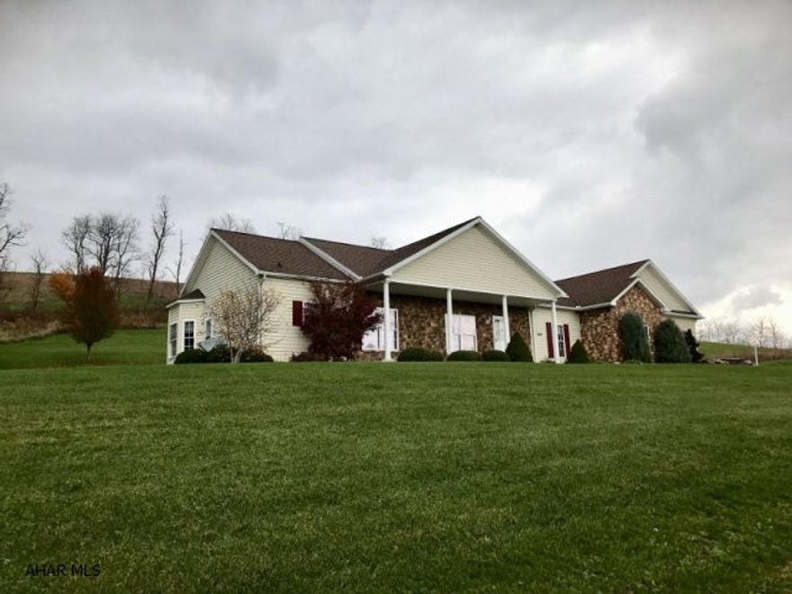 Gorgeous 3 bedroom, 2 bath, 3 car garage, one story living on close to an acre.. Central foyer designed with master suite and guest bedroom & guest bath on opposite sides of the home. High ceilings, many oversized windows and open concept design make this a great entertaining home. Tray ceilings in the dining room with its commanding views add appeal the moment you enter.  The high end custom kitchen with stunning cabinets, breakfast bar, huge pantry and breakfast nook are sure to impress. The walk out from the kitchen opens onto a brick paved terrace and impressive landscaping. Main floor laundry room is conveniently located off the kitchen. Fabulous inside and out!