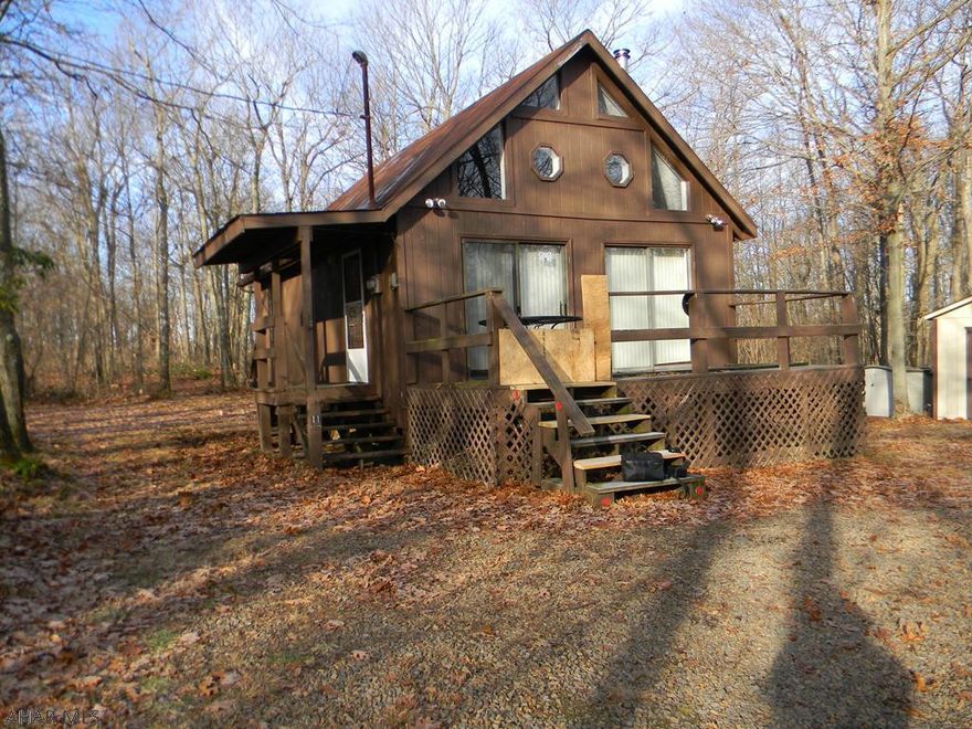 This wonderful property sits on top of the mountain behind New Paris . Perfect home or hunting cabin . Very private gated community. Lots of potential.