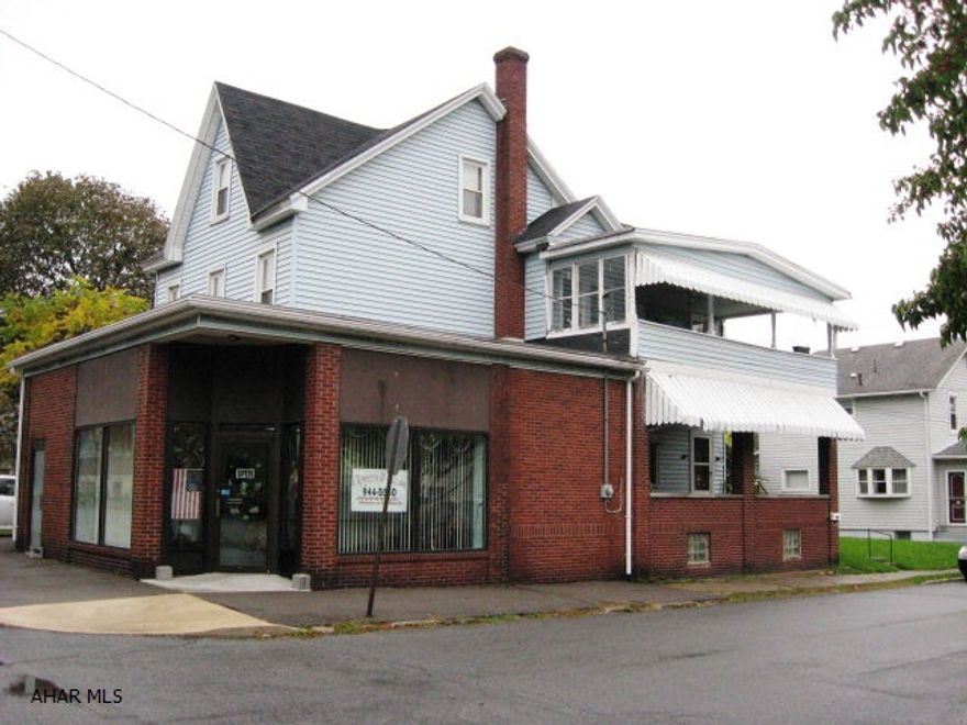 Excellent 3 unit investment property with long term tenants. 2 apts. plus local business. Brick/vinyl. Corner location. All separate utilities. Nicely updated apartments. Good mechanics, roof, windows, siding. Garage. Good return.